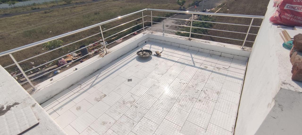 Tiled rooftop terrace with stainless steel railing